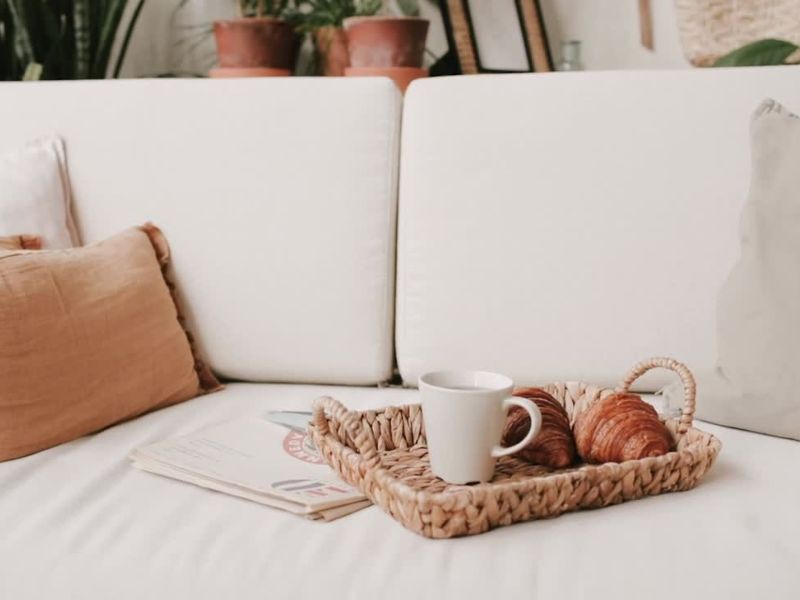 bela ugaona na kojoj je poslužavnik sa kafom i kroasanom